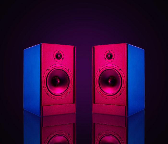 two-stereo-speakers-with-neon-light-on-dark-backgr-2021-12-09-13-51-17-utc-scaled.jpg